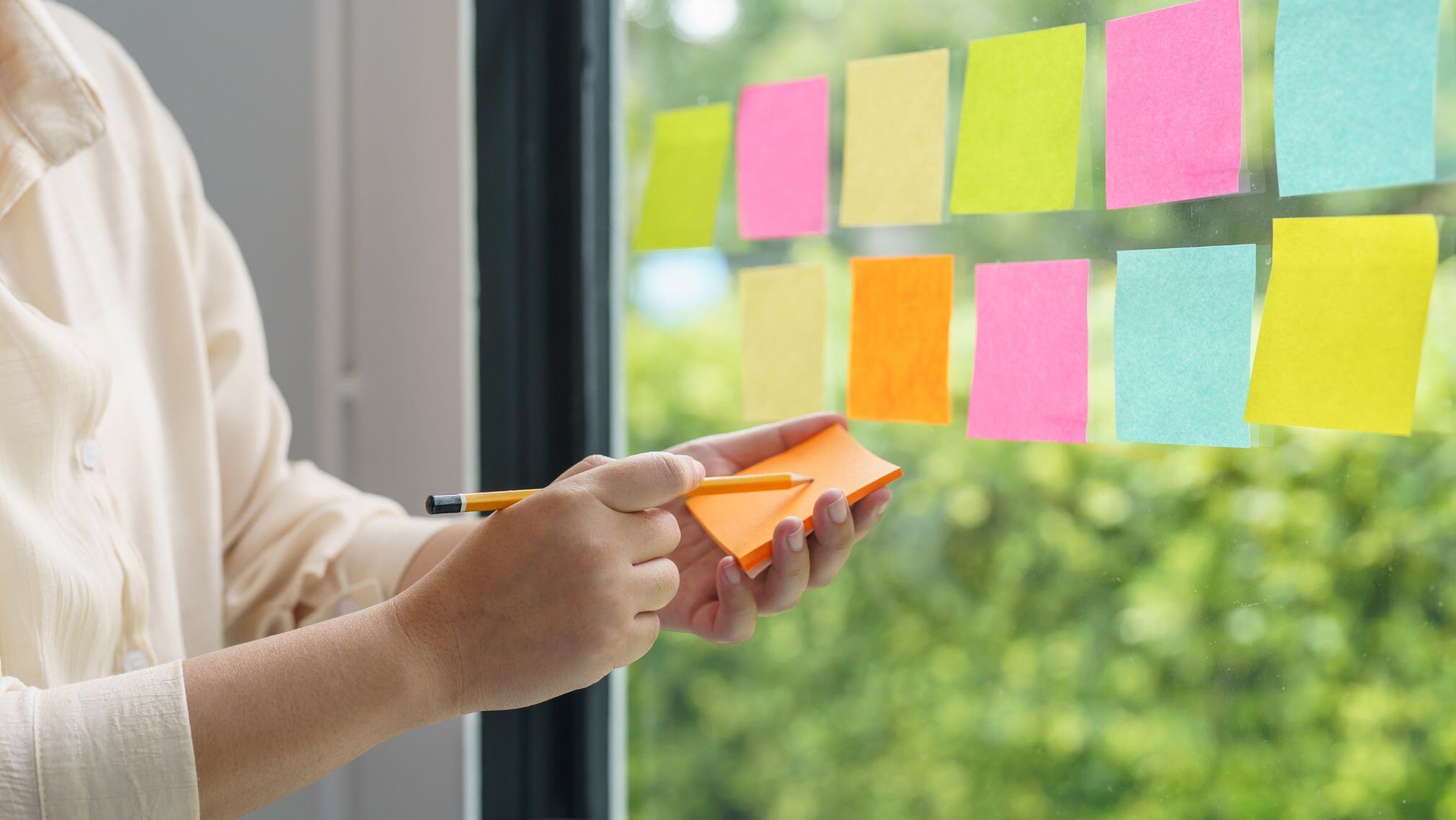 Woman at window brainstorms what she wants in a packaging provider