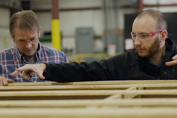 Pallet design engineers manufacturing and redesigning a wooden pallet